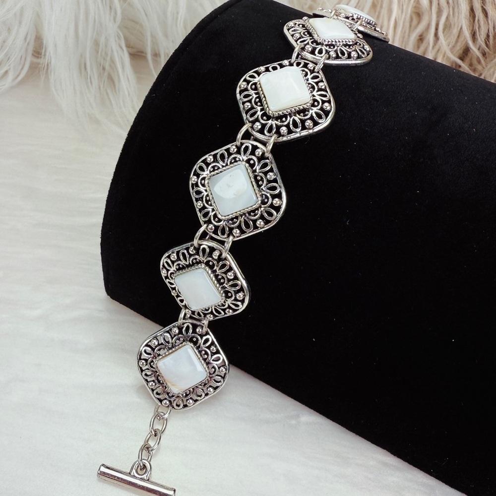 Beautiful Silvertone and white costume toggle closure bracelet